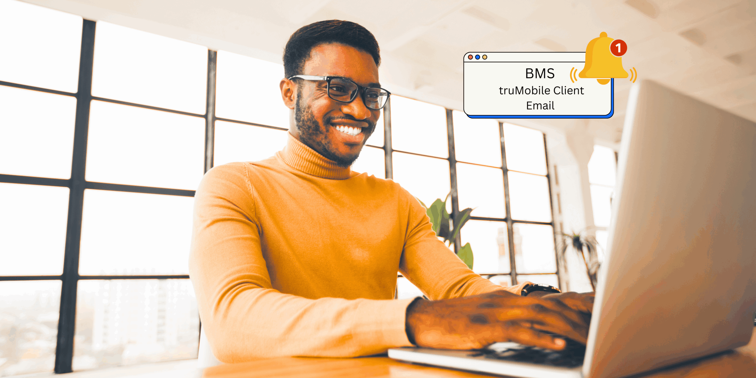 Smiling male adult working on computer