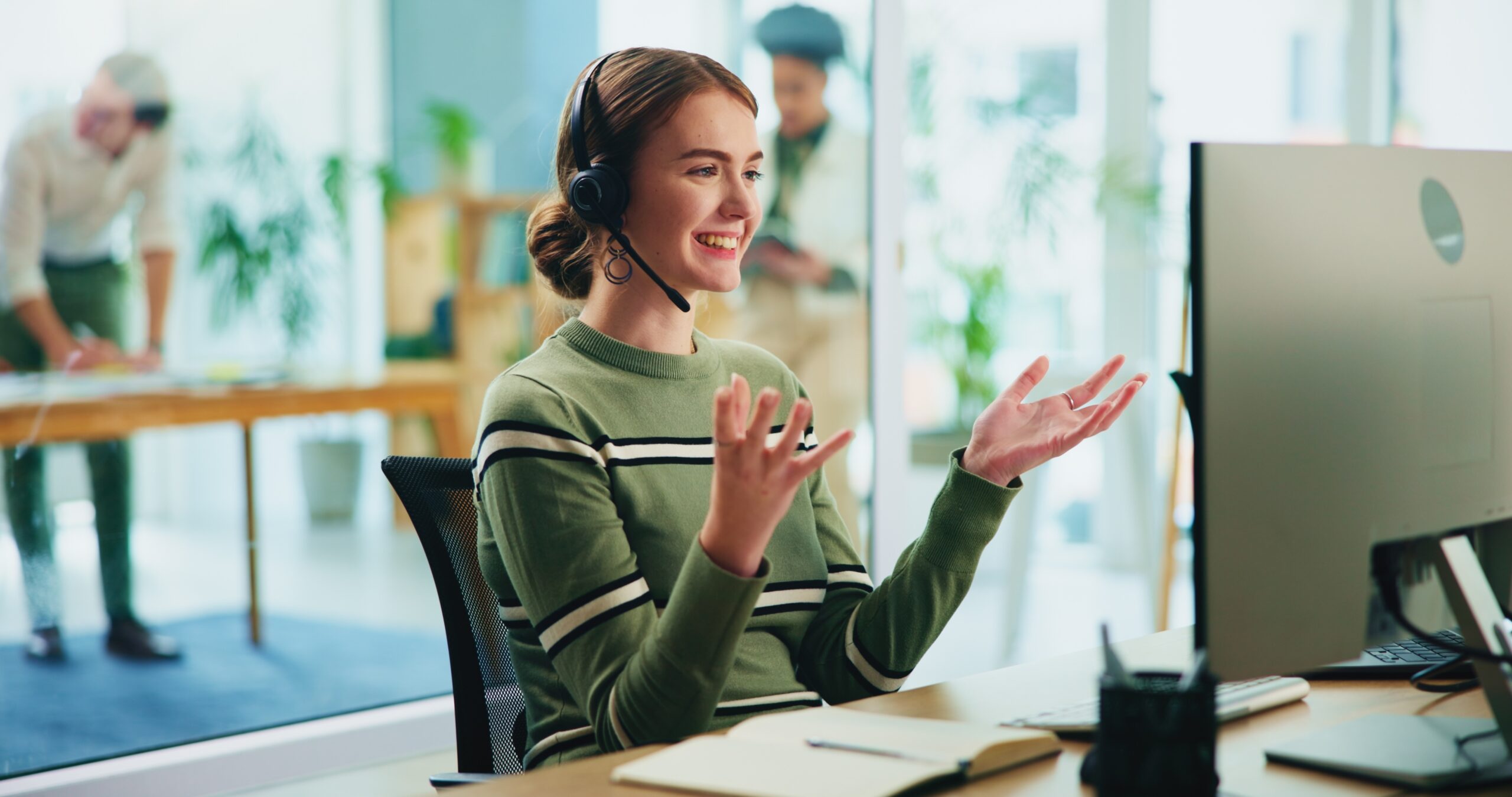 Happy call centre agent on the phone with a headset